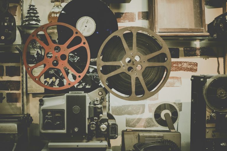 Two film reels on a table in a dim cinematographer’s room